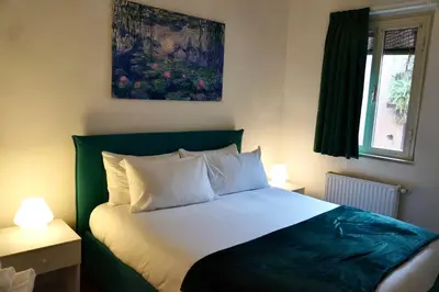 a bedroom with a large bed with white pillows at Emerald - in the heart of Trastevere in Rome