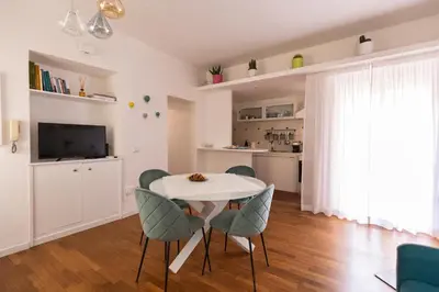a living room with a white table and chairs at Emerald - in the heart of Trastevere in Rome