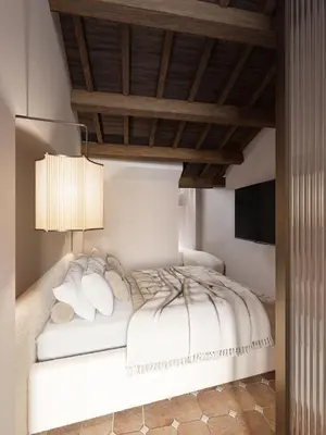 a bedroom with a white bed with a wooden ceiling at YourSuiteRome in Rome