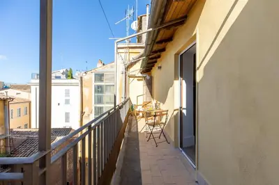 a balcony with a table and chairs on a building at iFlat The Great Beauty in Rome