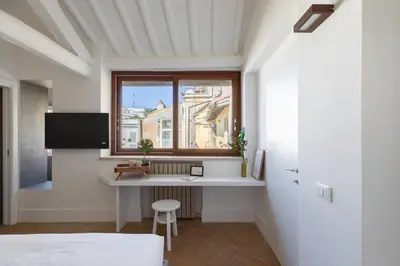 a bedroom with a desk and a window in a room at iFlat The Great Beauty in Rome