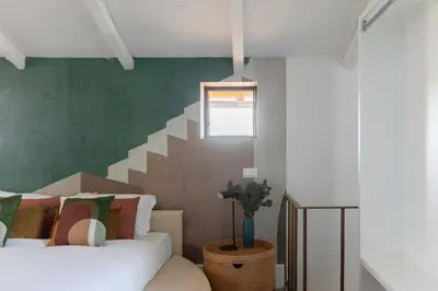 a bedroom with two beds and a staircase at iFlat The Great Beauty in Rome