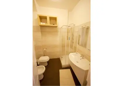 a bathroom with a toilet and a sink and a shower at Sophie's Choice in Rome