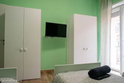 a bedroom with a bed and a tv on a wall at Sophie's Choice in Rome
