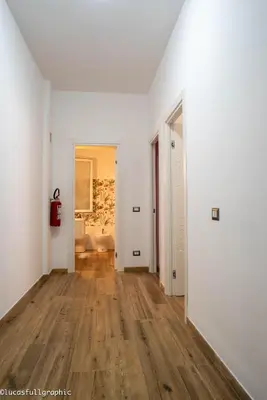 an empty room with white walls and a hard wood floor at Sophie's Choice in Rome