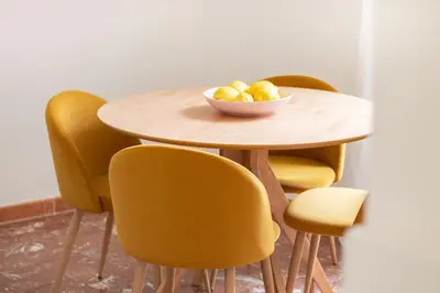 a table with yellow chairs and a bowl of fruit on it at Appartamento di Charme San Giovanni - Colosseo in Rome