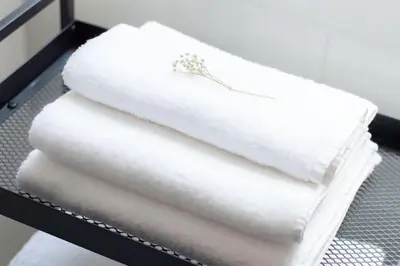a stack of white towels on a shelf at Appartamento di Charme San Giovanni - Colosseo in Rome