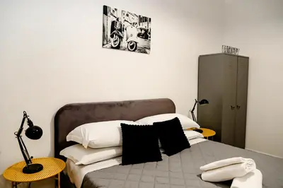 a bedroom with a bed with black and white pillows at MyWay RDR in Rome