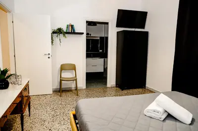 a bedroom with a bed and a desk and a chair at MyWay RDR in Rome