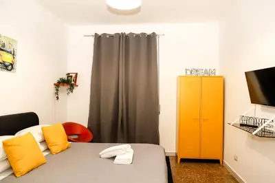 a room with a bed and a yellow cabinet at MyWay RDR in Rome