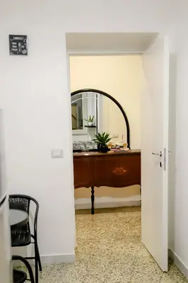 a hallway with a mirror and a desk with a chair at MyWay RDR in Rome