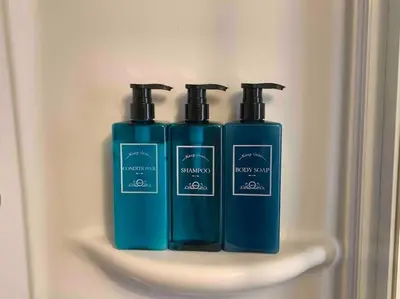 two blue bottles sitting on a shelf in a refrigerator at Your Happy Home in Rome