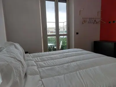 a white bed in a room with a window at Your Happy Home in Rome