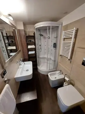 a bathroom with two sinks and a shower and a toilet at Your Happy Home in Rome