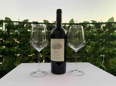 a bottle of wine and two wine glasses on a table at Your Happy Home in Rome