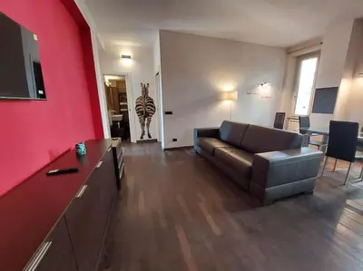 a living room with a couch and a red wall at Your Happy Home in Rome