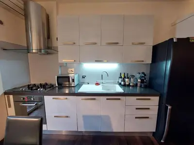 a kitchen with a sink and a black refrigerator at Your Happy Home in Rome