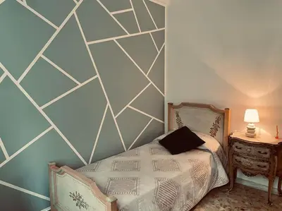 a bedroom with a bed with a hexagonal wall at Rome Opéra Flat 2.0 in Rome