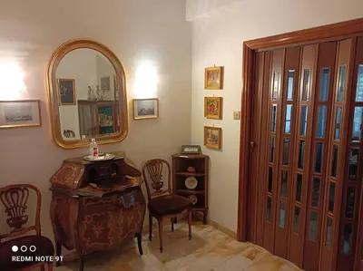 a room with a mirror and a table and chairs at Rome Opéra Flat 2.0 in Rome