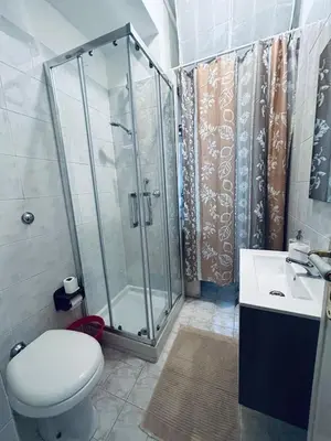 a bathroom with a shower and a toilet and a sink at Rome Opéra Flat 2.0 in Rome