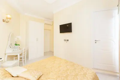 a white bedroom with a bed and a desk at Impero Vaticano San Pietro in Rome