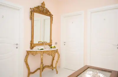 a bathroom with a gold mirror and a sink at Impero Vaticano San Pietro in Rome