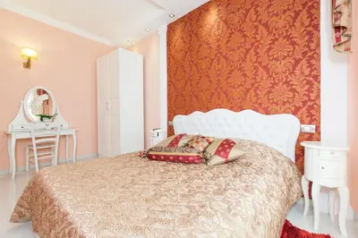 a bedroom with a bed and a red wall at Impero Vaticano San Pietro in Rome