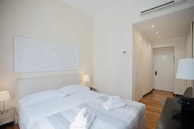 a bedroom with a white bed with towels on it at OperaDreams2 in Rome
