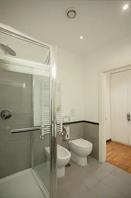 a bathroom with a toilet and a glass shower at OperaDreams2 in Rome