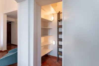 a room with white shelves and a bed at The Attico: best view of Rome in Rome