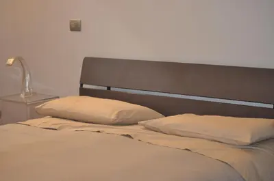 a bed with two pillows in a bedroom at A casa di Pelé suite in Rome