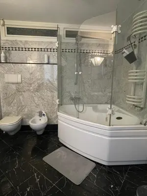 a bathroom with a shower and a tub and a sink at A casa di Pelé suite in Rome