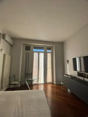 a bedroom with a bed and a table and a television at A casa di Pele in Rome