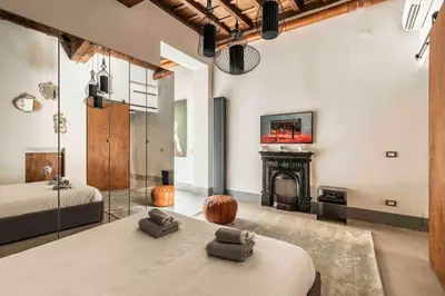a bedroom with two beds and a fireplace at Monti Art Loft in Rome