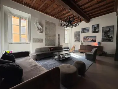 a living room with couches and a chandelier at Monti Art Loft in Rome