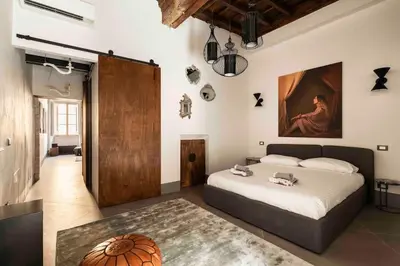 a bedroom with a bed and a painting on the wall at Monti Art Loft in Rome