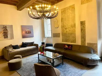 a living room with two couches and a chandelier at Monti Art Loft in Rome