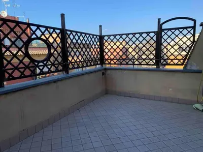 a balcony with a fence and a mirror on it at In Città- appartamento a Roma con terrazzo in Rome