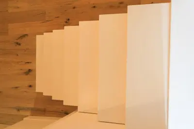 a white staircase in a room with a wooden wall at Via Veneto Luxury Loft in Rome