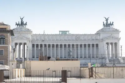 a large white building with statues on top of it at Amazing Piazza Venezia with Jacuzzi and terrace in Rome