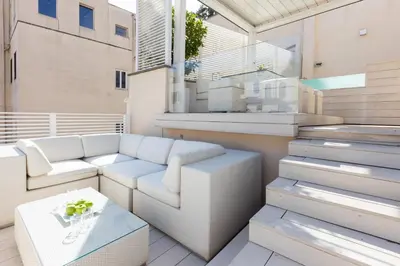 a balcony with a couch and a table at Amazing Piazza Venezia with Jacuzzi and terrace in Rome