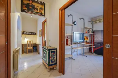 a hallway with a room with a television and a desk at Hostme Luminoso Appartamento Metro Marconi in Rome