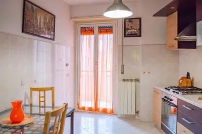 a kitchen with a table and a dining room at Hostme Luminoso Appartamento Metro Marconi in Rome