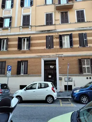 a white car parked in front of a building at ViviRome - 2 Bedrooms Apartment - San Giovanni in Rome
