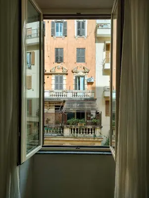 a window with a view of a building at ViviRome - 2 Bedrooms Apartment - San Giovanni in Rome