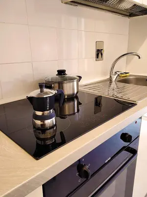 a stove top in a kitchen with a pot on it at ViviRome - 2 Bedrooms Apartment - San Giovanni in Rome