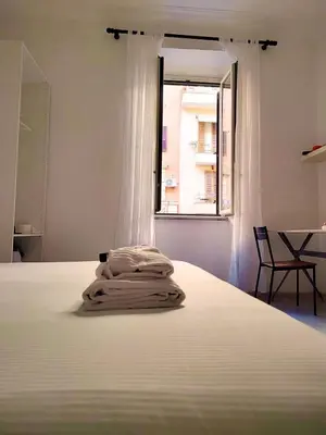 a bedroom with a white bed with a window at ViviRome - 2 Bedrooms Apartment - San Giovanni in Rome