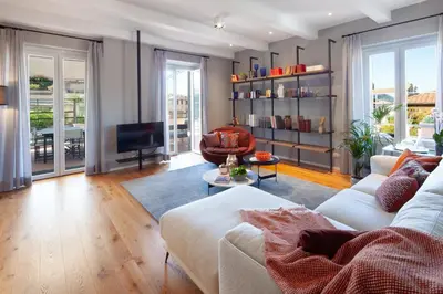 a living room with a couch and a television at Migliori Collection Penthouse in Rome