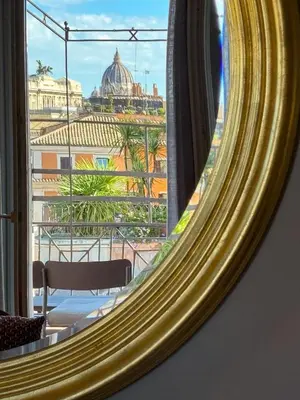 a mirror with a view of the vatican from a hotel room at Migliori Collection Penthouse in Rome