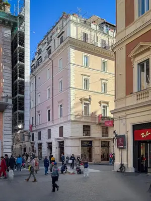 a group of people walking down a street in front of a building at Migliori Collection Penthouse in Rome